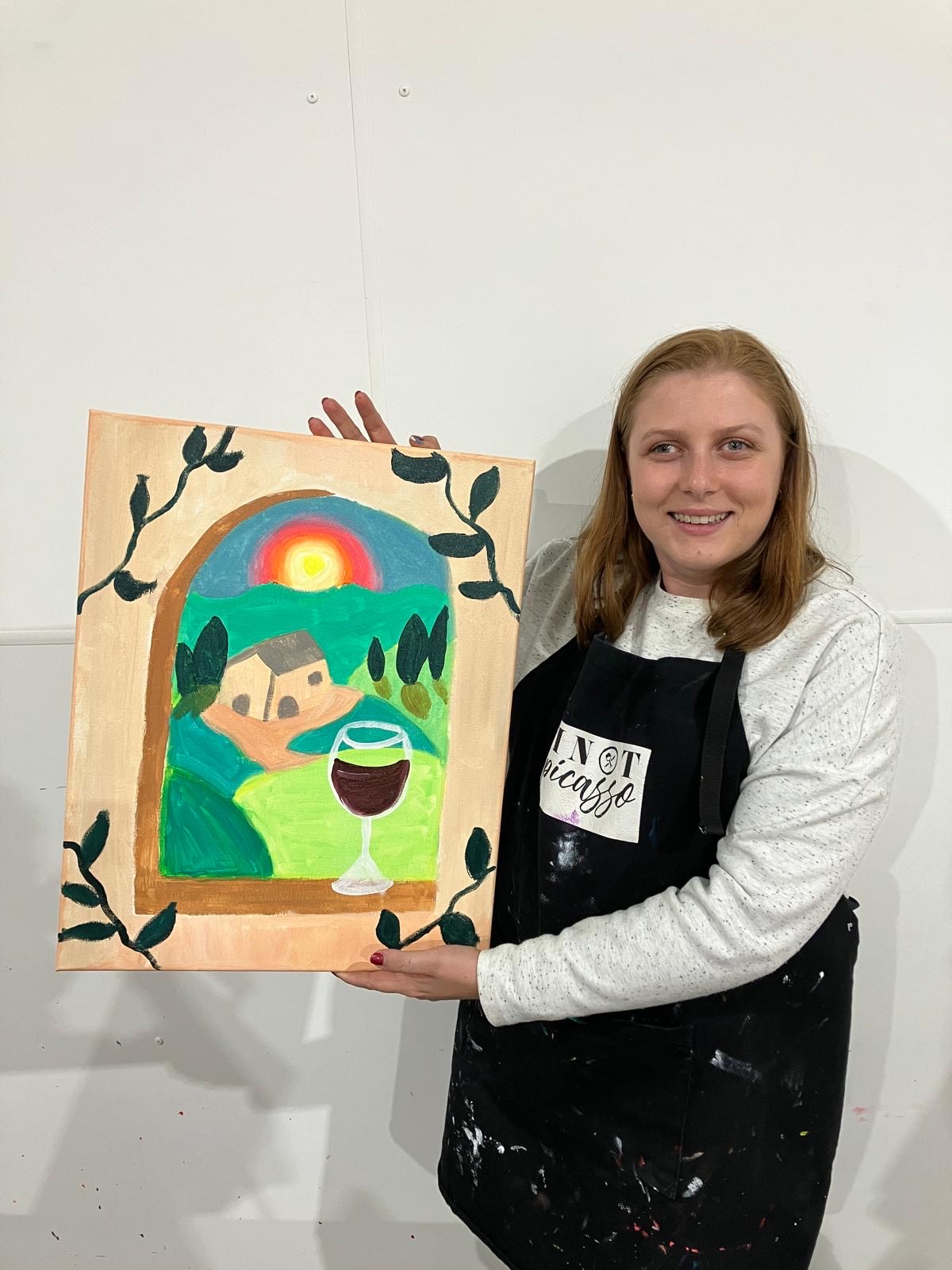 Olivia holds up a painting; her brain tumour is not stopping her from living life to the fullest